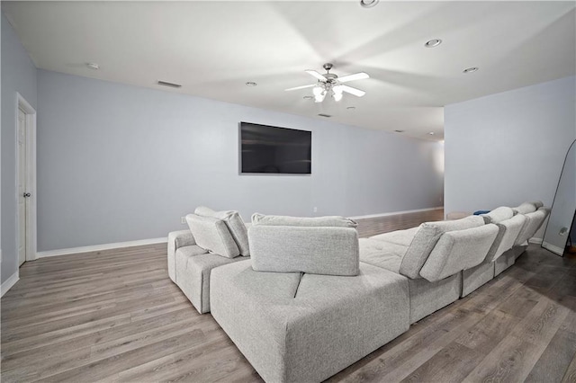 living room featuring hardwood / wood-style flooring and ceiling fan