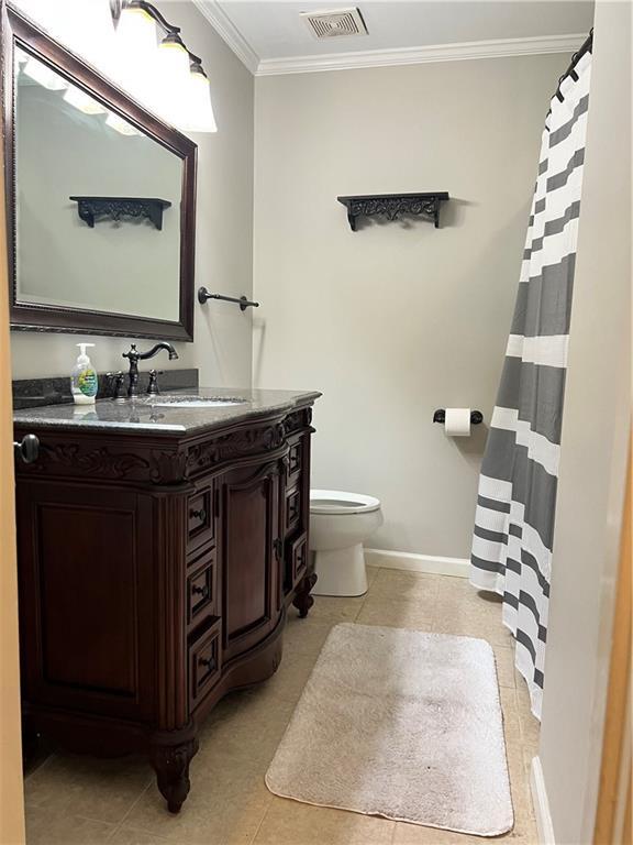 5855 Zeigler Blvd, Mobile, AL 36608 - bathroom with toilet, baseboards, visible vents, vanity, and ornamental molding