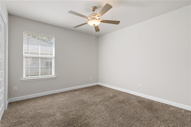 carpeted spare room featuring ceiling fan