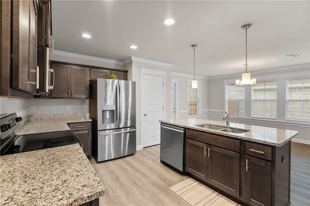 kitchen with sink, a center island with sink, light stone countertops, and appliances with stainless steel finishes