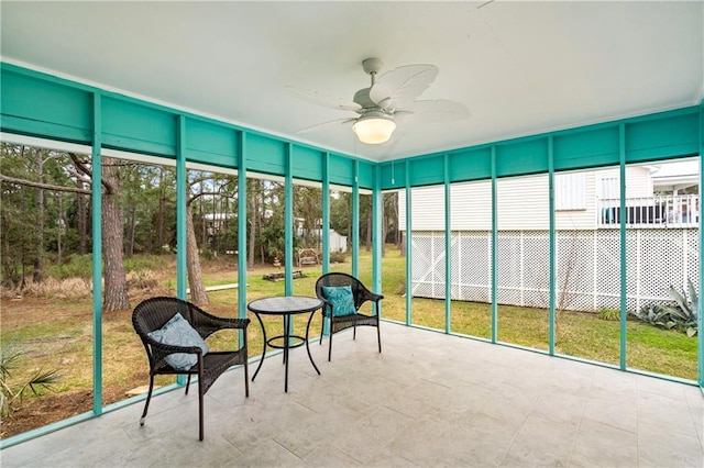 sunroom / solarium featuring ceiling fan