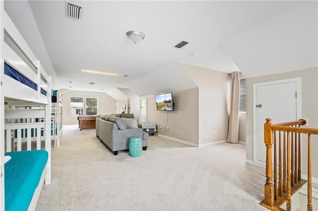 living area featuring carpet floors, vaulted ceiling, and baseboards