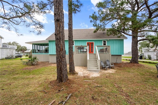 back of house with stairs, roof with shingles, a yard, and a wooden deck