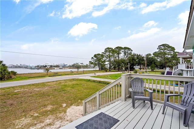 deck featuring a water view and a lawn
