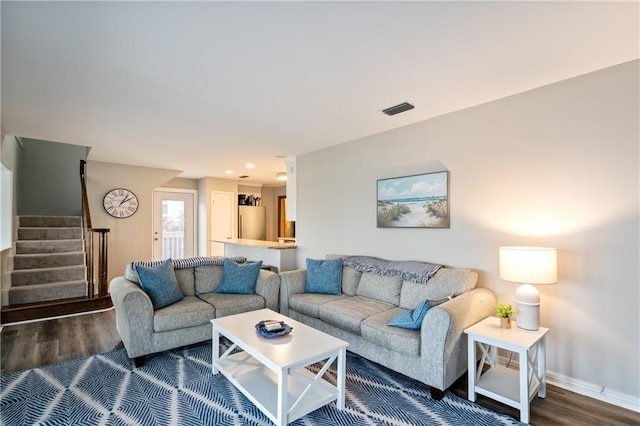 living room featuring dark wood-style floors, stairway, baseboards, and recessed lighting