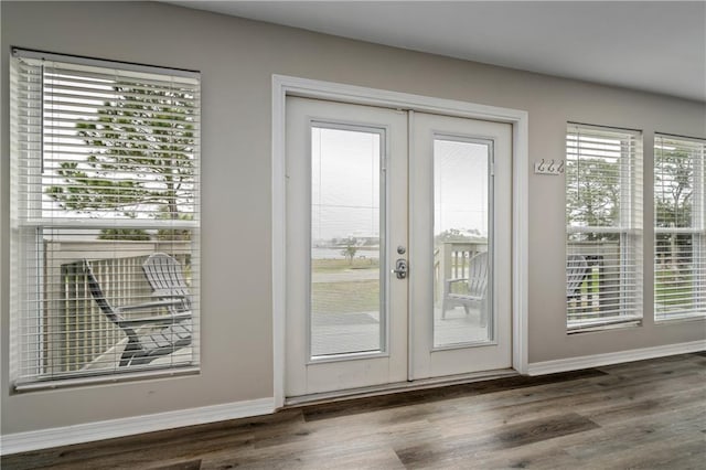 doorway to outside with wood finished floors, french doors, and baseboards