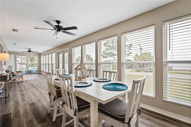 dining space featuring ceiling fan, wood finished floors, and baseboards