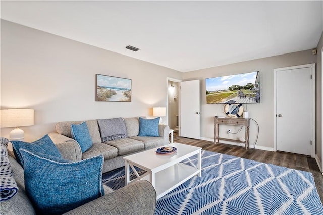 living room featuring wood finished floors and baseboards