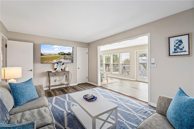 living area with wood finished floors and baseboards