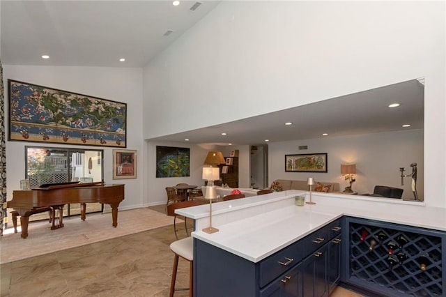 6000 Shenandoah Rd N, Mobile, AL 36608 - kitchen featuring open floor plan, light countertops, blue cabinetry, a breakfast bar area, and high vaulted ceiling
