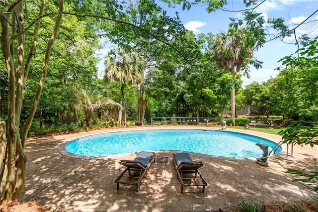 6000 Shenandoah Rd N, Mobile, AL 36608 - view of pool featuring view of wooded area, fence, and a patio area