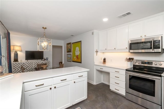 6000 Shenandoah Rd N, Mobile, AL 36608 - kitchen featuring stainless steel appliances, light countertops, white cabinetry, a peninsula, and recessed lighting