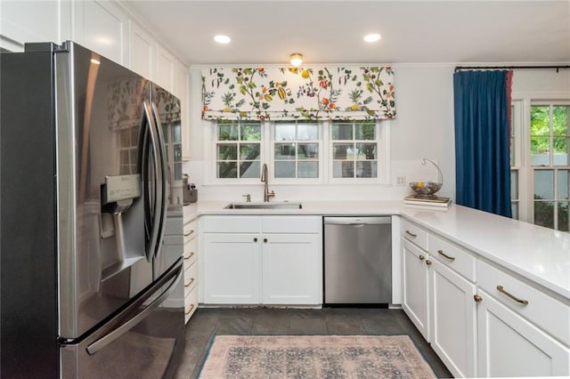 6000 Shenandoah Rd N, Mobile, AL 36608 - kitchen with stainless steel appliances, a sink, white cabinets, light countertops, and recessed lighting