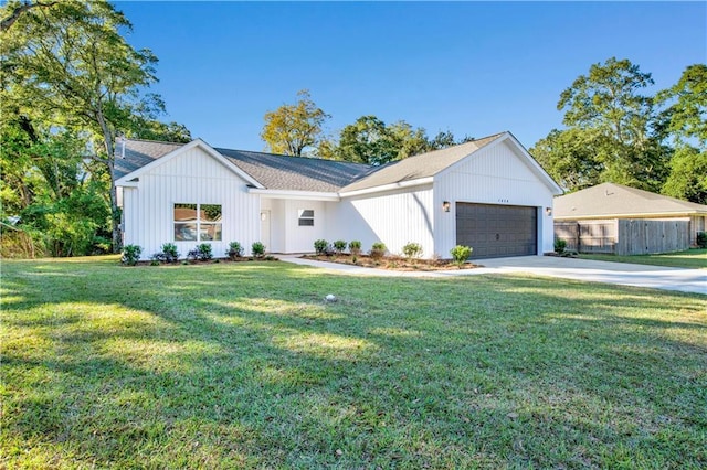 modern inspired farmhouse with a garage and a front yard