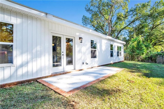 rear view of property featuring a patio area and a lawn