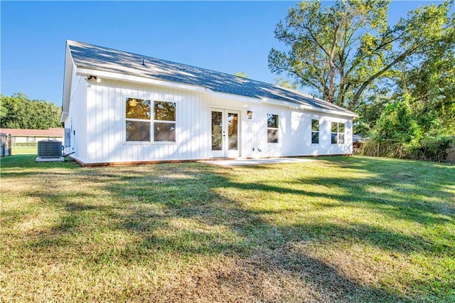 back of house with french doors, central AC, and a lawn