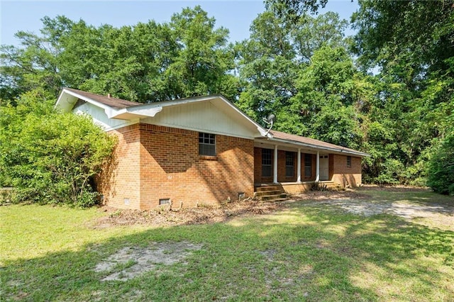 66 Mccoy Ave, Satsuma, AL 36572 - view of front of home featuring a front lawn, brick siding, and a porch