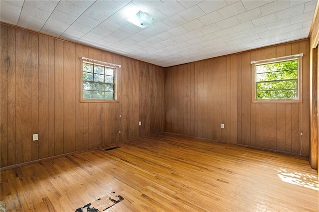 66 Mccoy Ave, Satsuma, AL 36572 - empty room featuring light wood-style flooring and wood walls