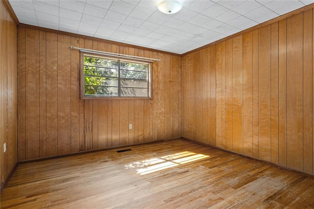 66 Mccoy Ave, Satsuma, AL 36572 - empty room with wood-type flooring and wooden walls