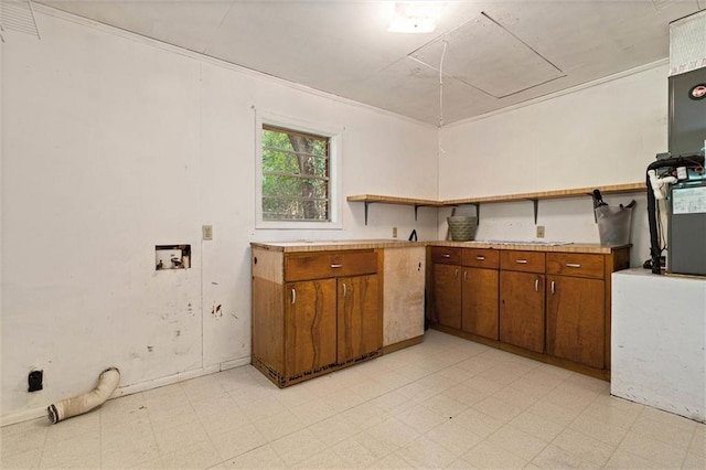 66 Mccoy Ave, Satsuma, AL 36572 - kitchen featuring light floors, brown cabinetry, light countertops, and open shelves