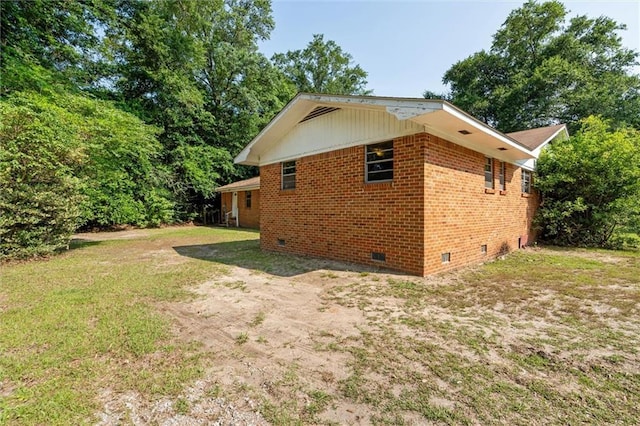 66 Mccoy Ave, Satsuma, AL 36572 - view of side of home with crawl space, brick siding, and a yard