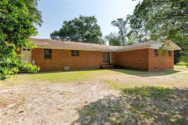 66 Mccoy Ave, Satsuma, AL 36572 - back of house featuring crawl space, entry steps, brick siding, and a lawn