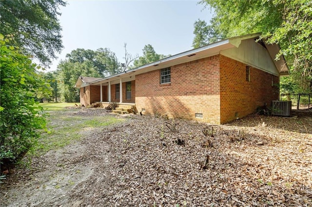 66 Mccoy Ave, Satsuma, AL 36572 - rear view of house featuring crawl space, central air condition unit, and brick siding