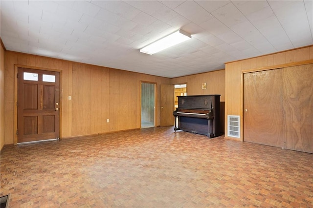 66 Mccoy Ave, Satsuma, AL 36572 - unfurnished living room with wood walls and baseboards