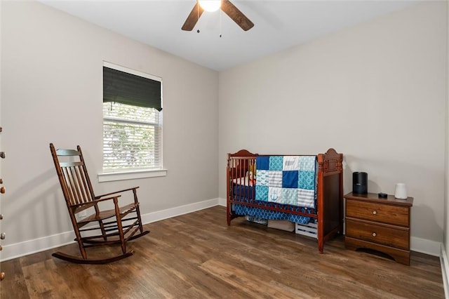 bedroom with dark wood-style floors and baseboards