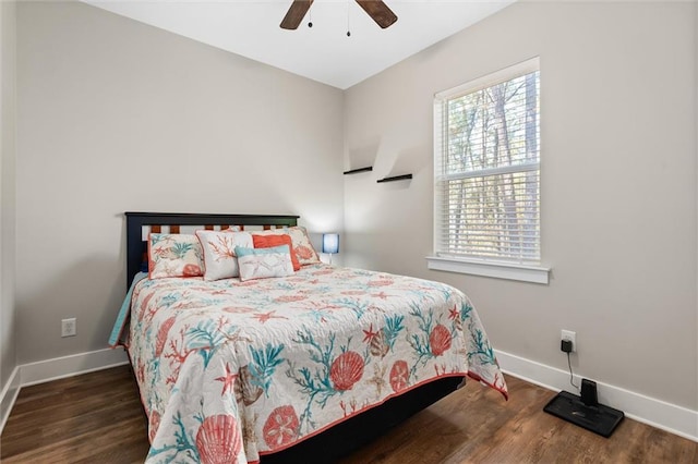 bedroom with baseboards, dark wood finished floors, and a ceiling fan