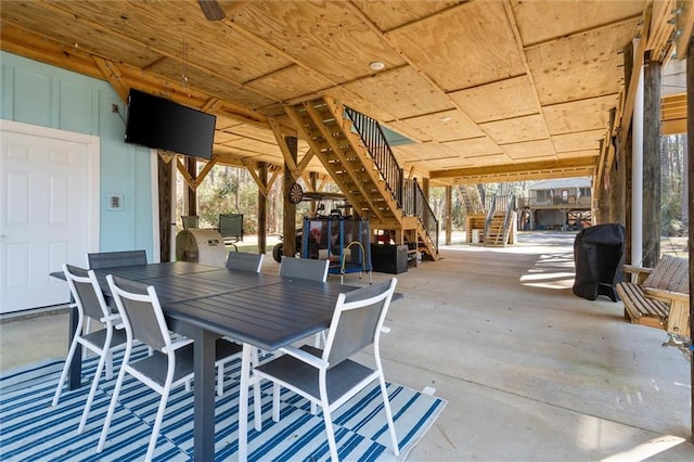 view of patio with outdoor dining area and stairway