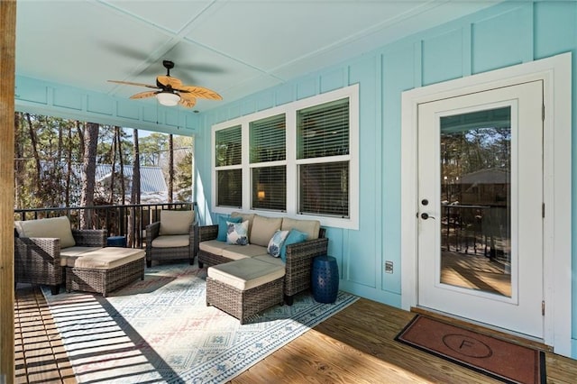 sunroom featuring a ceiling fan