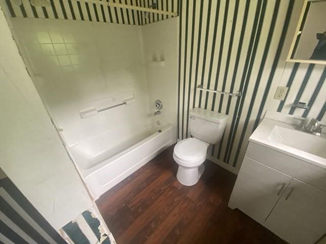351 Lincoln Blvd, Mobile, AL 36608 - bathroom with wallpapered walls, wood finished floors, toilet, vanity, and shower / bathtub combination