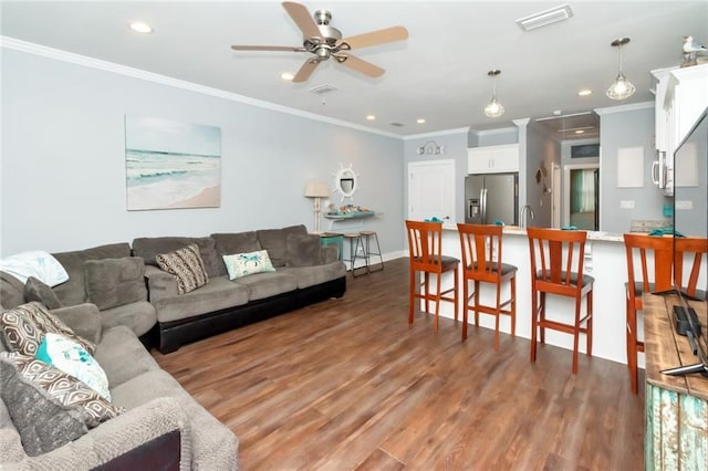 living room with ornamental molding, sink, ceiling fan, and dark hardwood / wood-style flooring