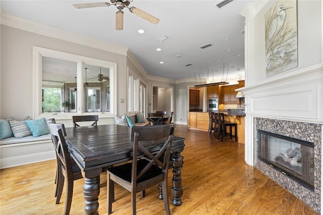 6060 Riverchase Dr S, Mobile, AL 36619 - dining area featuring a ceiling fan, light wood-style floors, recessed lighting, crown molding, and a high end fireplace
