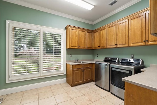 6060 Riverchase Dr S, Mobile, AL 36619 - laundry room featuring washing machine and clothes dryer, cabinet space, ornamental molding, and light tile patterned floors