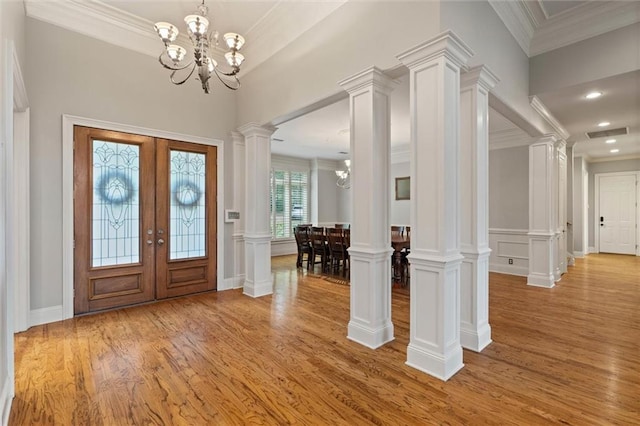 6060 Riverchase Dr S, Mobile, AL 36619 - entrance foyer with light wood-style floors, a chandelier, ornamental molding, recessed lighting, and decorative columns