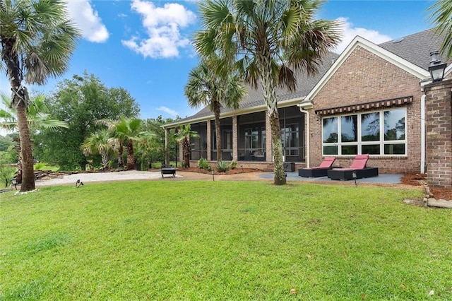 6060 Riverchase Dr S, Mobile, AL 36619 - back of house with a patio area, brick siding, a lawn, and a sunroom