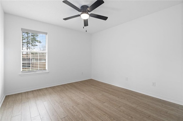 empty room featuring ceiling fan and light hardwood / wood-style flooring