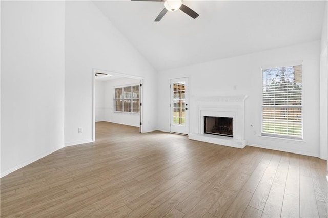 unfurnished living room featuring ceiling fan, high vaulted ceiling, and light hardwood / wood-style floors