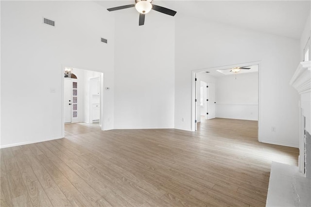 unfurnished living room featuring light hardwood / wood-style flooring, ceiling fan, and vaulted ceiling