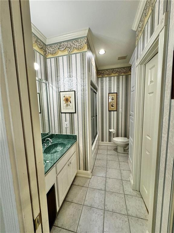 bathroom featuring tile patterned flooring, vanity, toilet, and ornamental molding