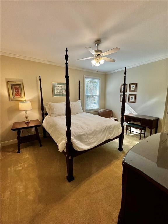 bedroom featuring carpet, ceiling fan, and crown molding