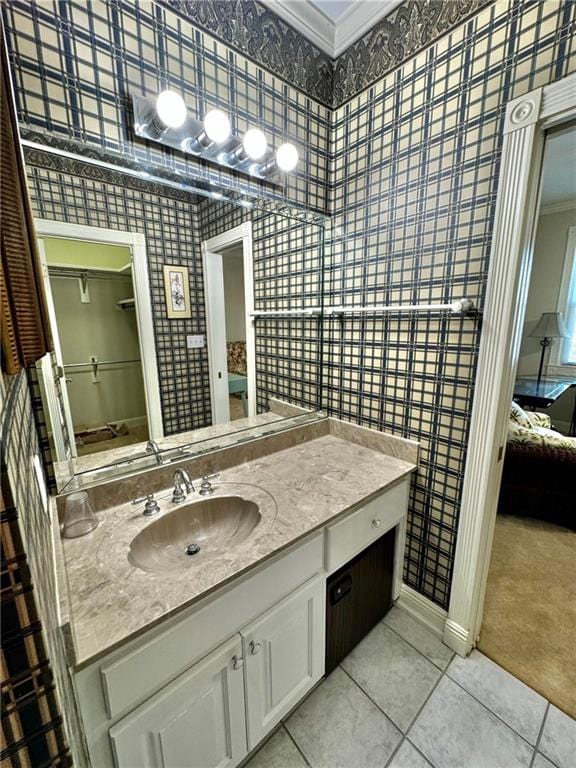 bathroom featuring tile patterned flooring, vanity, and ornamental molding