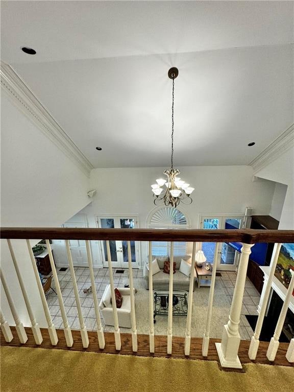 staircase featuring carpet floors, a chandelier, and ornamental molding