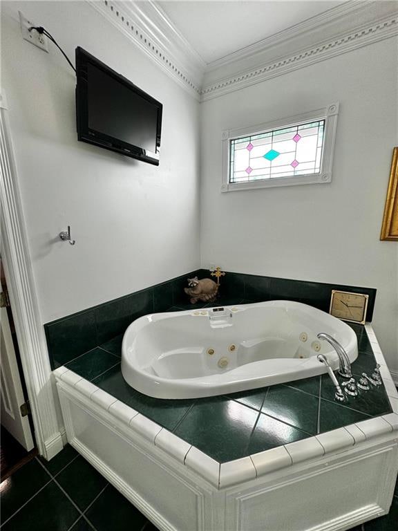 bathroom featuring tile patterned floors, ornamental molding, and a tub