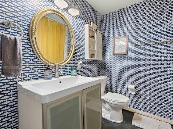 bathroom with toilet and large vanity