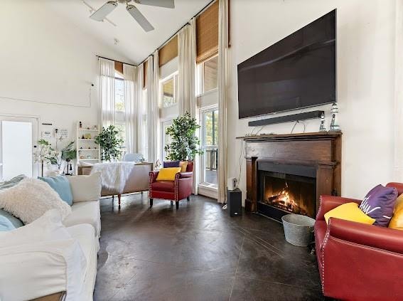 living room featuring high vaulted ceiling and ceiling fan