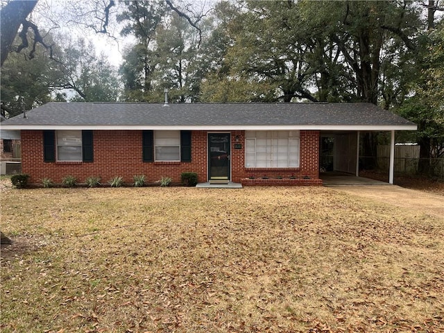 ranch-style house featuring a carport and a front yard