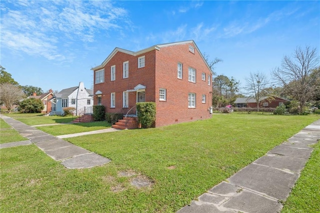 view of side of home with brick siding, crawl space, and a lawn